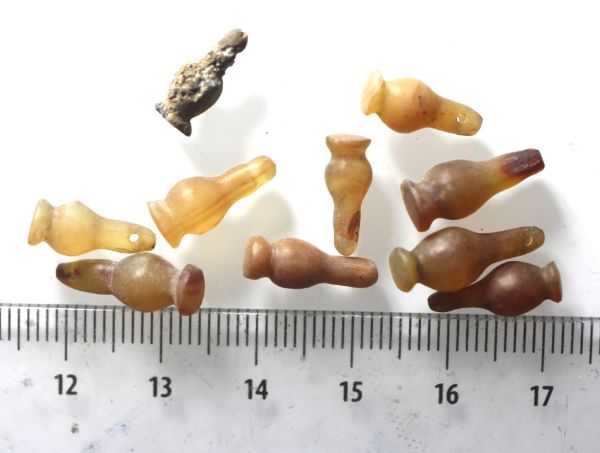 Picture of DEALER'S LOT:  ANCIENT EGYPT . LOT OF 10 CARNELIAN POPPY SEED AMULET. 1200 B.C . NEW KINGDOM