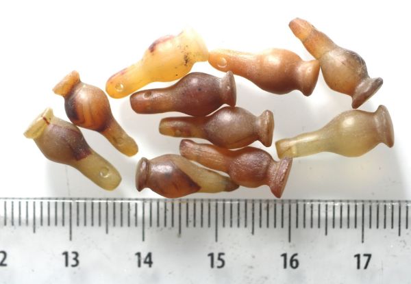 Picture of DEALER'S LOT:  ANCIENT EGYPT . LOT OF 10 CARNELIAN POPPY SEED AMULET. 1200 B.C . NEW KINGDOM