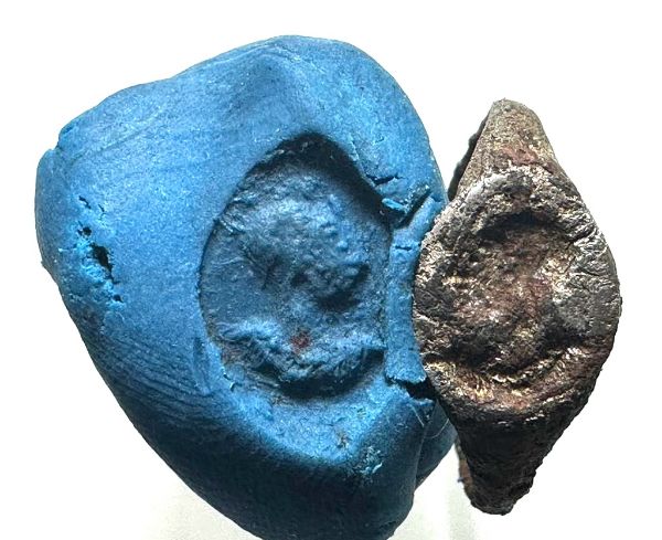 Picture of Roman Egypt. Silver(?) signet ring. 3rd century AD. Incuse draped and helmeted male bust r.