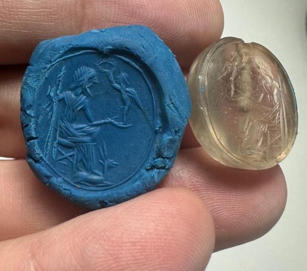 Picture of Greek. 450 - 300 B.C.  Rock crystal scarboid seal (21 x 19 x 8 mm). Pierced for string. Incuse Zeus(?) 