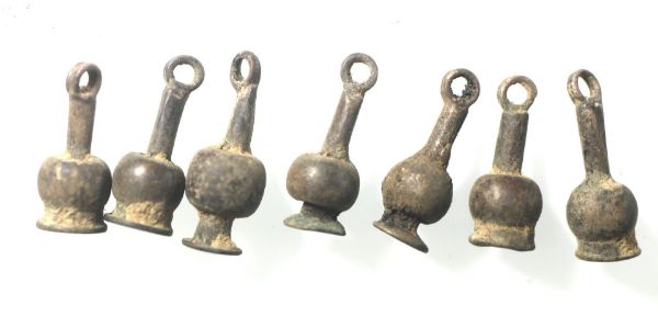 Picture of Ancient Egypt. A group of 7  silver Poppy seed amulets. Ptolemaic Period.