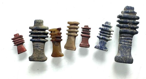 Picture of  Ancient Egypt.   LOT OF 7 STONE DJED PILLAR AMULETS  . Ptolemaic Period. 3rd century B.C