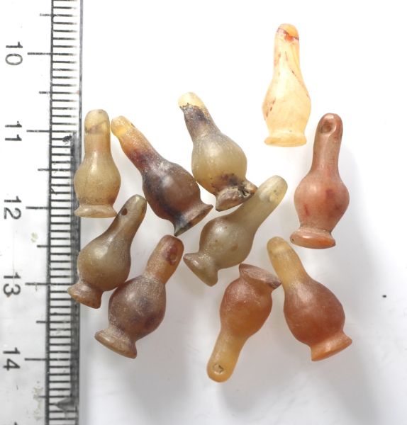 Picture of   Ancient Egypt. LOT OF 10 CARNELIAN STONE POPPY SEED AMULETS. 600 - 300 B.C