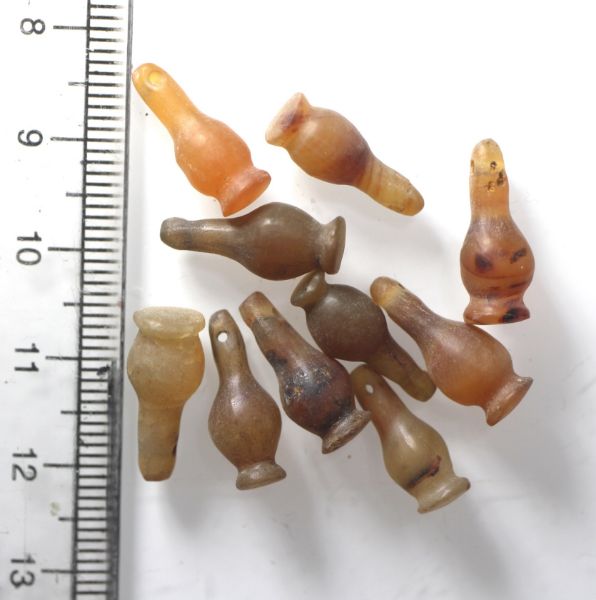 Picture of  Ancient Egypt. LOT OF 10 CARNELIAN STONE POPPY SEED AMULETS. 600 - 300 B.C