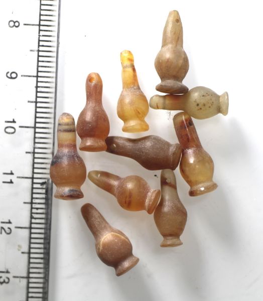 Picture of   Ancient Egypt. LOT OF 10 CARNELIAN STONE POPPY SEED AMULETS. 600 - 300 B.C