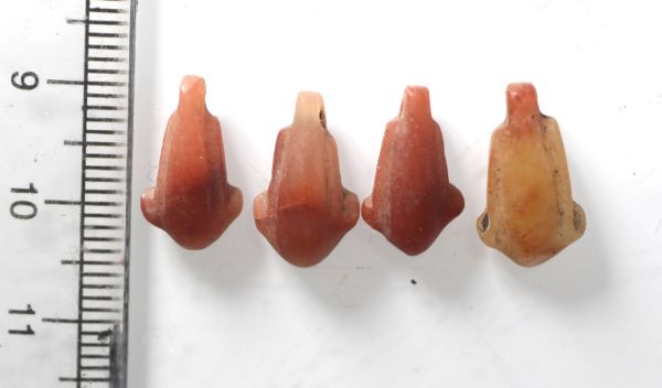 Picture of   Ancient Egypt. LOT OF 4 CARNELIAN LOTUS FLOWER  AMULETS. 600 - 300 B.C